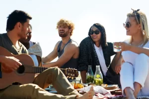 A group of friends having a picnic as group staycation ideas