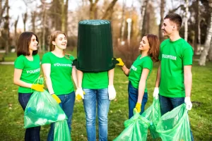 A group of young staff members taking part in a volunteer cleanup day day for a charity