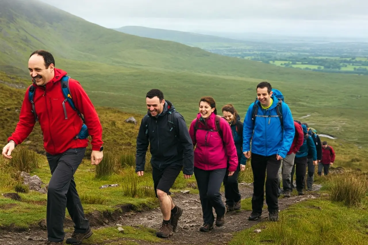 A group of adults hiking on an Irish mountain for their work social ideas